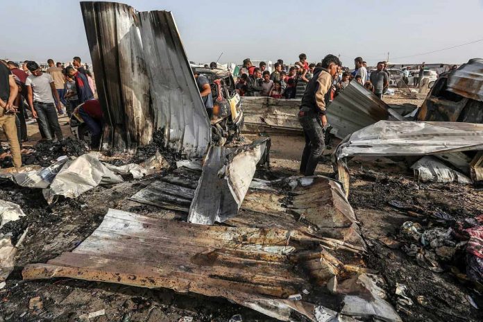 Palestinians inspect damage after an Israeli airstrike in Al-Mawasi, west of Rafah in the southern Gaza Strip, May 27, 2024. Photo by Abed Rahim Khatib-Flash90.