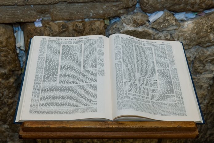 Open Talmud on a book stand next to the Western Wall
